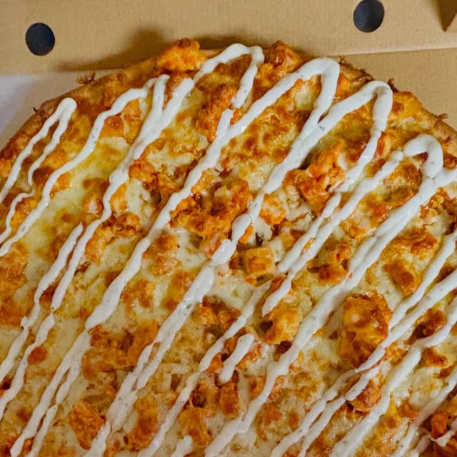 Buffalo chicken pizza with ranch drizzle